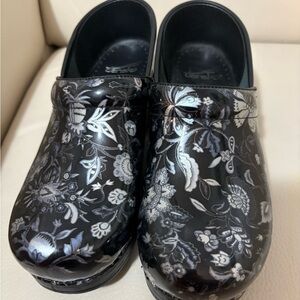 Dansko Black Floral Patent Clogs